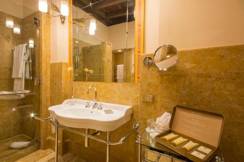 
a bathroom with a sink, toilet, and bathtub at Hotel Corona d'Oro in Bologna
