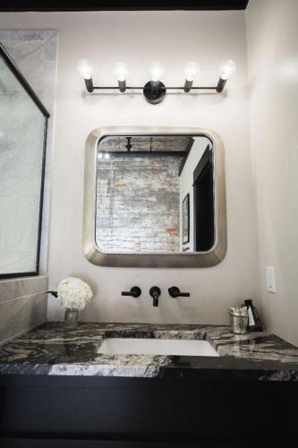 a bathroom with a sink and a mirror at GunRunner Boutique Hotel in Florence