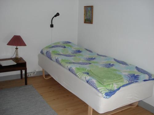 uma cama com um cobertor num quarto em Jysse's Bed & Bath em Nykobing Sjaelland