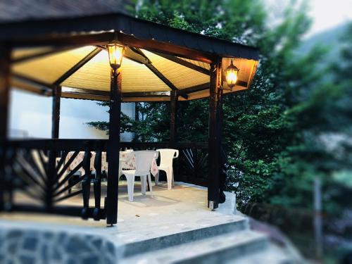 a gazebo with two chairs and a table at Chez Marcel Sinaia in Sinaia