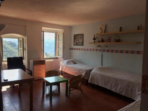 a bedroom with a bed and a table and chairs at Cinqueterre - Terrace and beautiful view in Levanto