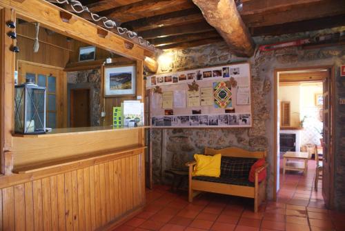 a restaurant with a counter and a chair in a room at Casas do Cruzeiro in Sabugueiro