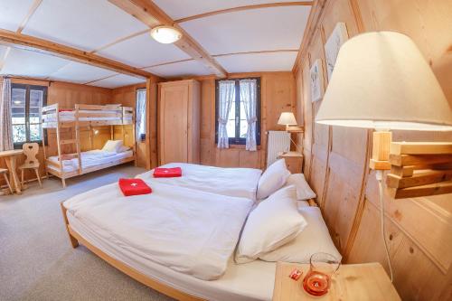 a bedroom with a large bed in a room at Guest House du Grand Paradis - On Piste in Champéry