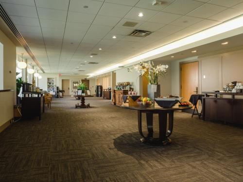 a lobby with a table in the middle of a room at Donald Gordon Hotel and Conference Centre in Kingston