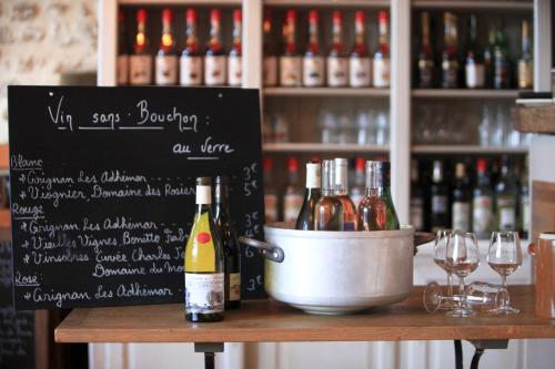 a table with bottles of wine and wine glasses at Domaine Les Mejeonnes in Valaurie