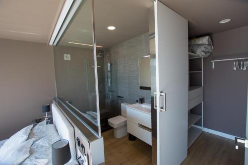 Un baño con ducha, lavabo e inodoro. en A Xanela Indiscreta, en Redondela
