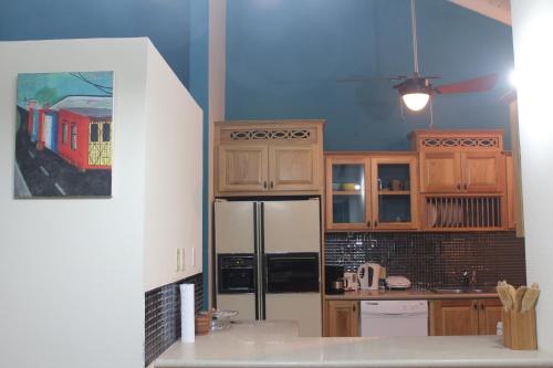 a kitchen with a train painting on the wall at Driftwood 85 in Canaan