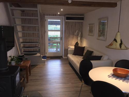a living room with a couch and a table at Hegnsly in Odder
