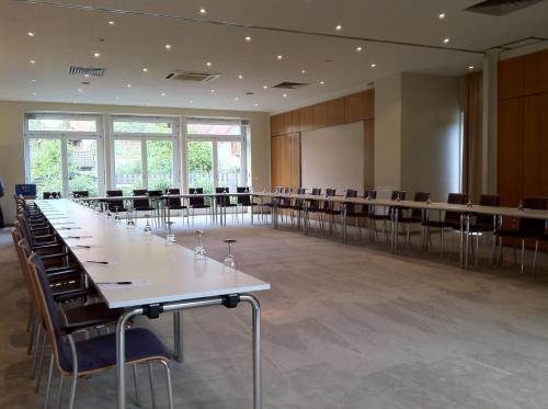 a large conference room with tables and chairs at Hotel Ambiente Walldorf in Walldorf