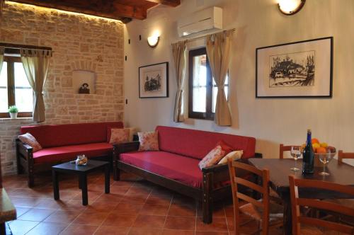 a living room with red couches and a table at Apartments Oliva in Fiorini