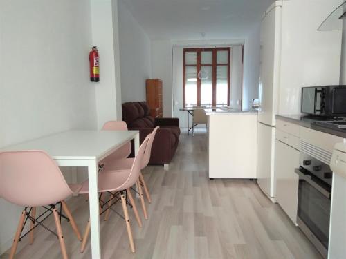 a kitchen and living room with a table and chairs at Disfruta - Enjoy Valencia Ruzafa in Valencia