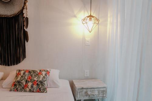 a room with a bed and a table and a light at Villas H2O in Tulum