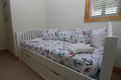 a white crib with a bedspread with crabs on it at Whalebone Ocean Cottages by KEES Vacations in Nags Head