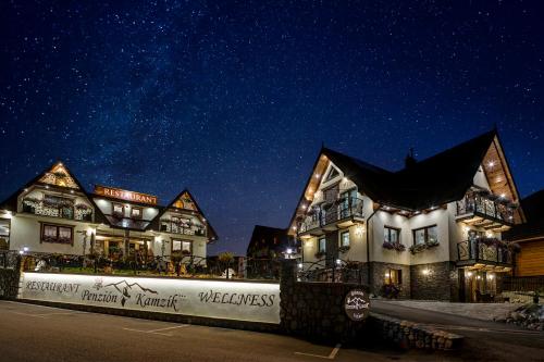 a row of houses at night with a starry sky at Wellness Resort Kamzík in Ždiar