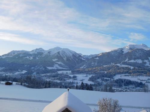 a view of a mountain range with snow on the ground at Ferienhaus Obwallhof in Fieberbrunn