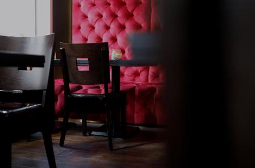 a dining room with a table and two chairs at König`s Hotel am Schlosspark in Rheda-Wiedenbrück