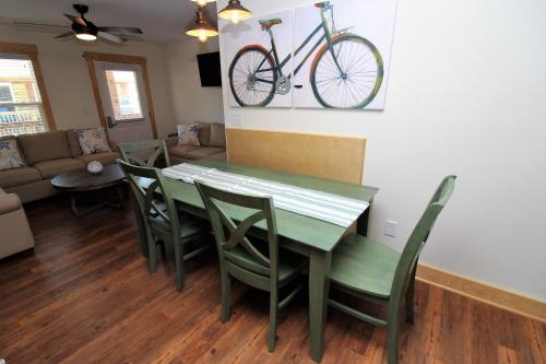 a dining room with a table and chairs and a bike on the wall at Whalebone Ocean Cottages by KEES Vacations in Nags Head