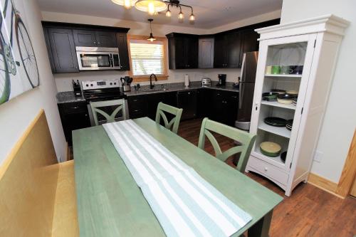 a kitchen with a table and chairs in a room at Whalebone Ocean Cottages by KEES Vacations in Nags Head