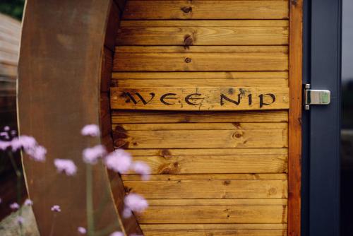a wooden door with the words usage up written on it at Delny Glamping and Farm Animals in Invergordon