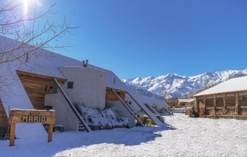 a building in the snow with a sign in front at San Francisco Lodge in Los Andes