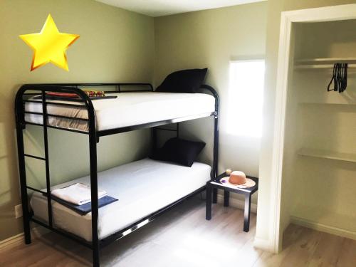 a bedroom with two bunk beds with a yellow star on the wall at Hollywood Stay in Los Angeles