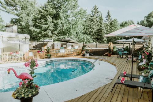 a swimming pool with a pink flamingo on a wooden deck at Northridge Inn & Resort in Sundridge