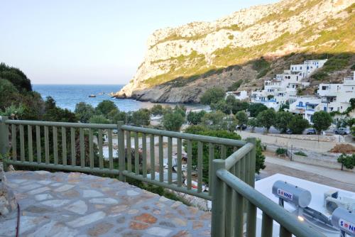 a balcony with a view of the ocean and white buildings at Delfinaki studio in Lionas