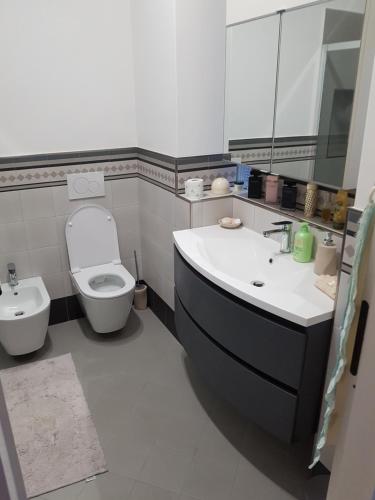a bathroom with a sink and a toilet and a tub at La Cameretta in Ischia