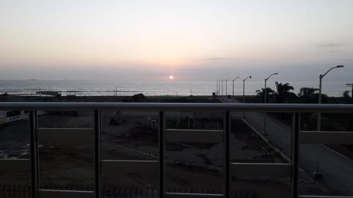 a view of the ocean at sunset from a balcony at Hospedaje Casablanca in Pisco
