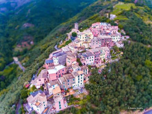 a village on a hill with houses on it at Cinqueterre - Terrace and beautiful view in Levanto