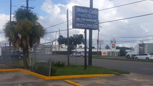 a sign for a motel on the side of a road at Monte Carlo Motel in New Orleans