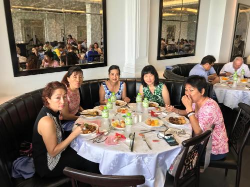 a group of women sitting at a table eating food at Hotel Morobe in Lae
