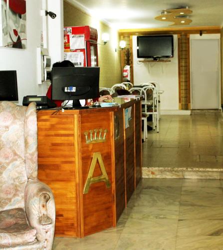 a room with a desk with a computer on it at Avenida Hotel in Junín
