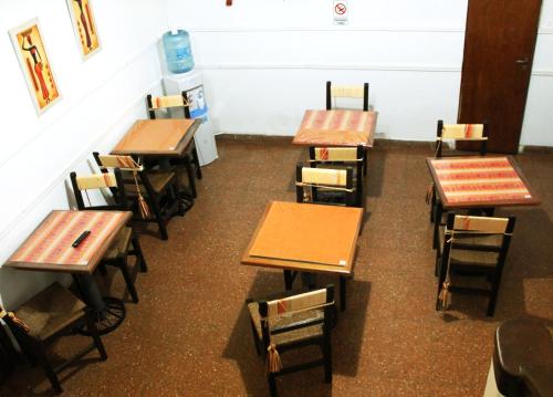 a row of desks in a classroom with books at Avenida Hotel in Junín