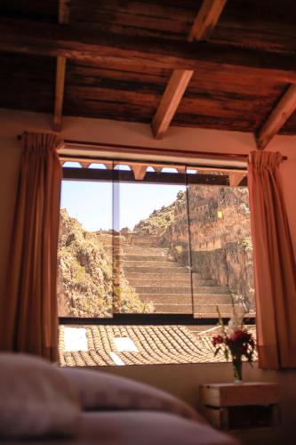 a window with a view of a mountain view at Eureka Lodge in Ollantaytambo