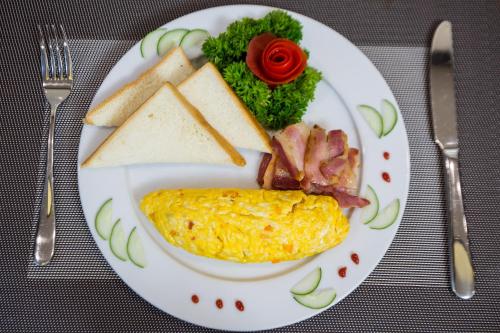 a plate of breakfast food with eggs bacon and toast at Splendid Star Grand Hotel and Spa in Hanoi