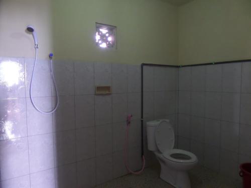 a bathroom with a shower and a toilet at Tengger Indah Homestay in Bromo