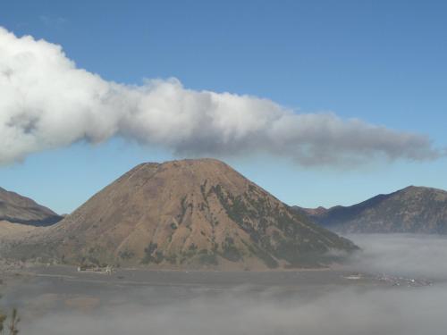 a mountain in the middle of a body of water at Tengger Indah Homestay in Bromo