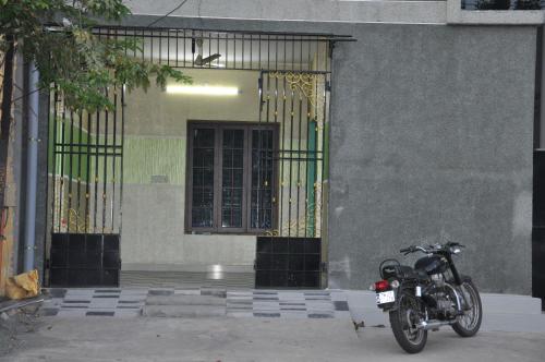 a motorcycle parked in front of a building at Moonlight Residency in Tiruchchirāppalli