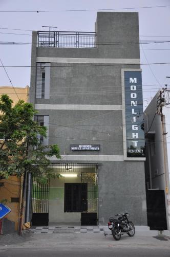 a motorcycle parked in front of a building at Moonlight Residency in Tiruchchirāppalli
