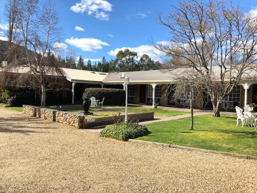 a house with a statue of a deer in the yard at Bright Avenue Motor Inn in Bright