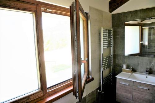 a bathroom with a sink and a large window at Il Casale Della Gioia in Melfi