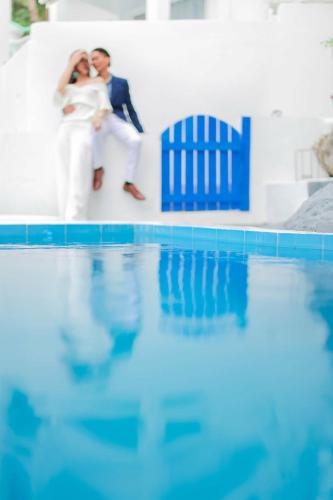 a bride and groom standing next to a swimming pool at Bintana Sa Paraiso in Mambajao