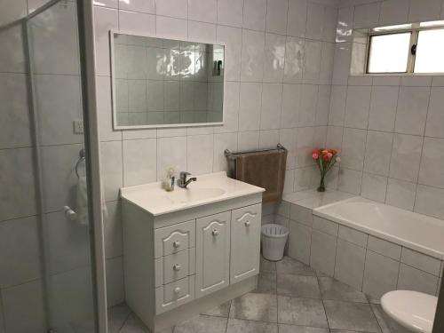 a bathroom with a sink and a tub and a toilet at Beachside & Jetty View Apartment 6 - Captain's Apt in Streaky Bay