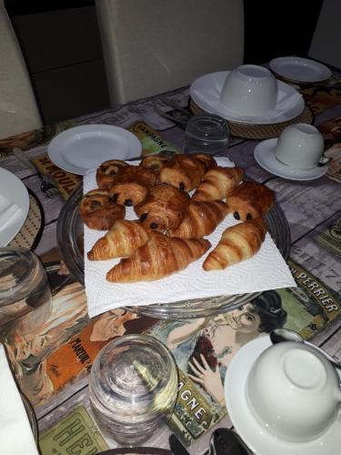 a table with croissants and other pastries on it at Fauzia B&B in Hamrun