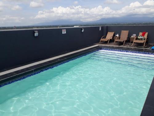 a swimming pool on the roof of a building at 913Cityscape located at city center in Bacolod