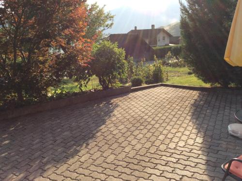 a brick driveway in a yard with a house at La Bergerie - chalet Alice in Choex