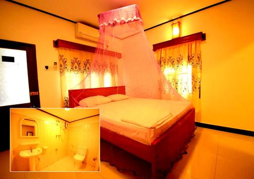 a bedroom with a large bed with a canopy at Yuthika Resort in Negombo