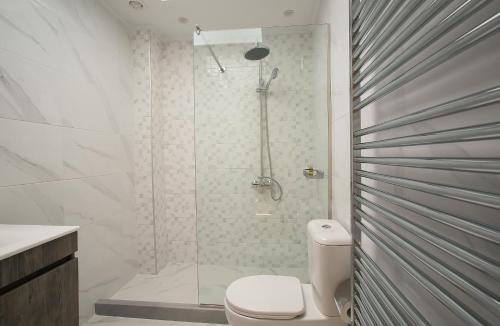 a bathroom with a shower and a toilet in it at Penelope Corfu Suite in Corfu Town