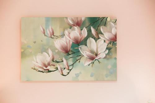 a painting of pink magnolia flowers on a wall at Penelope Corfu Suite in Corfu Town